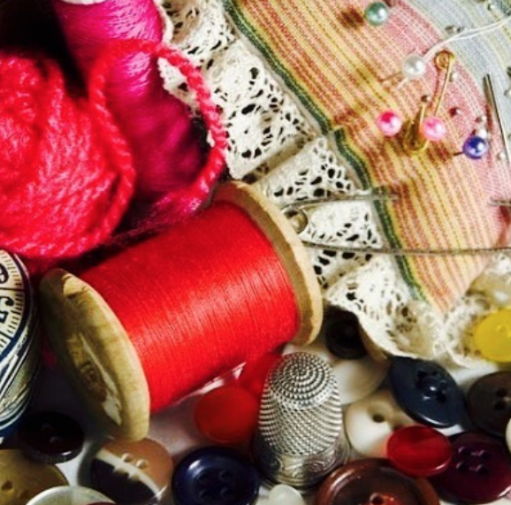 A bunch of sewing supplies including yarn and buttons