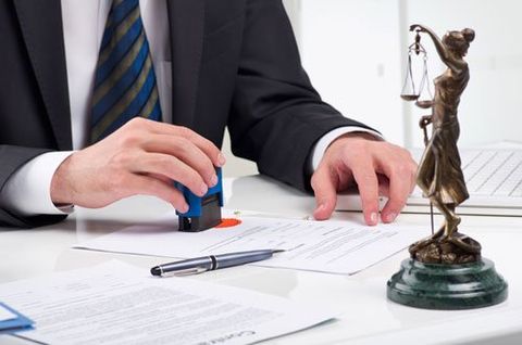 Attorney - Notary public signing document at his workplace in Cloud, MN Attorney - Notary public signing document at his workplace in Cloud, MN