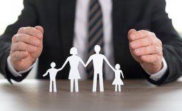 Businessman Showing a Family Made of Paper — Insurance Agency Stuart FL Businessman Showing a Family Made of Paper — Insurance Agency Stuart FL