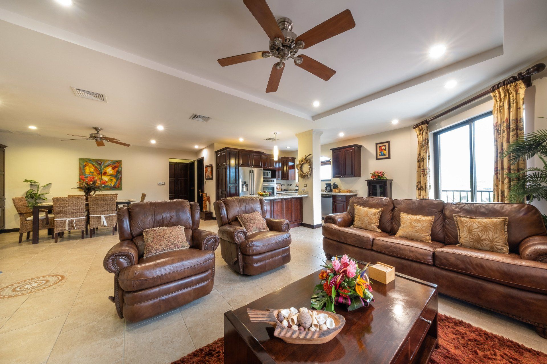 A living room filled with furniture and a ceiling fan.