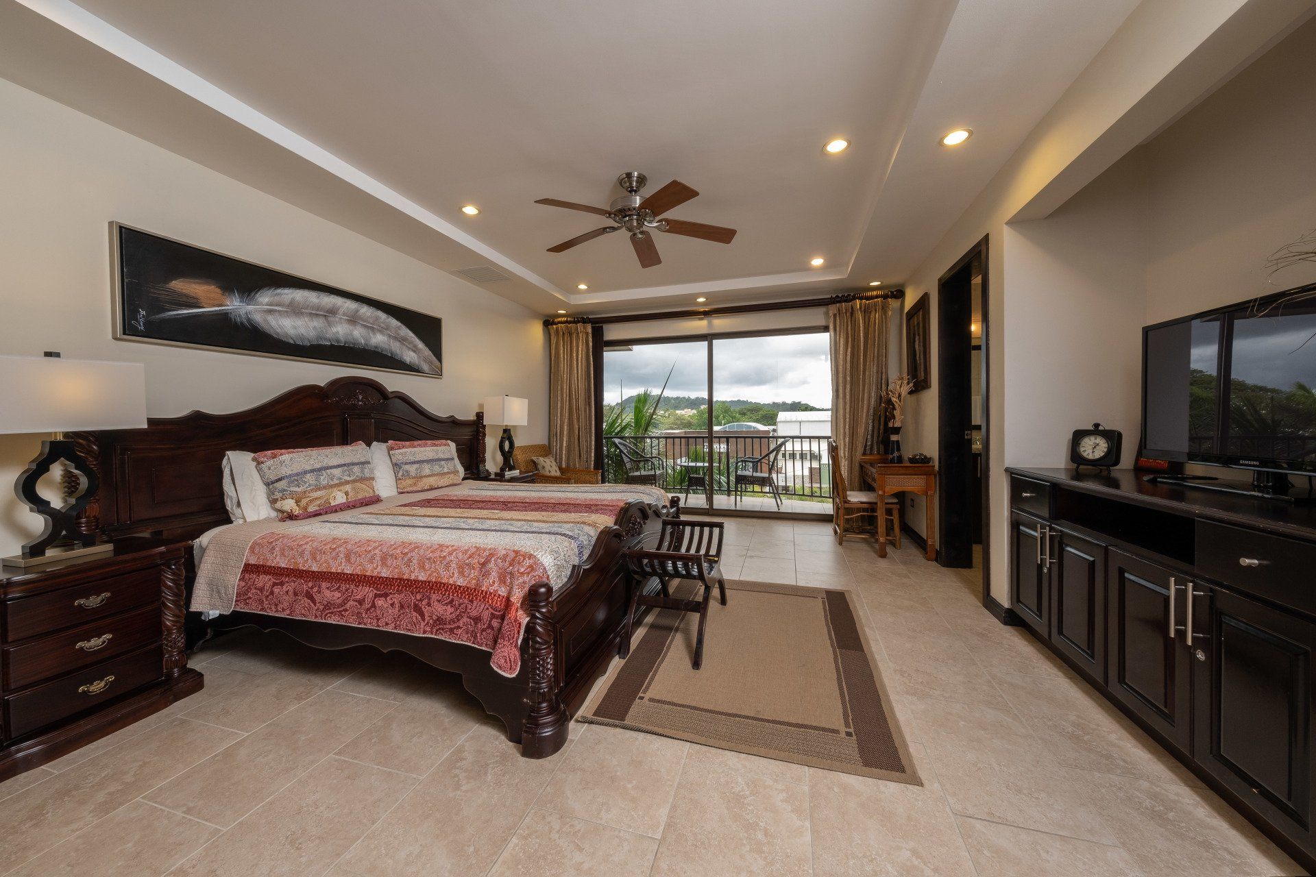 A bedroom with two beds and a ceiling fan