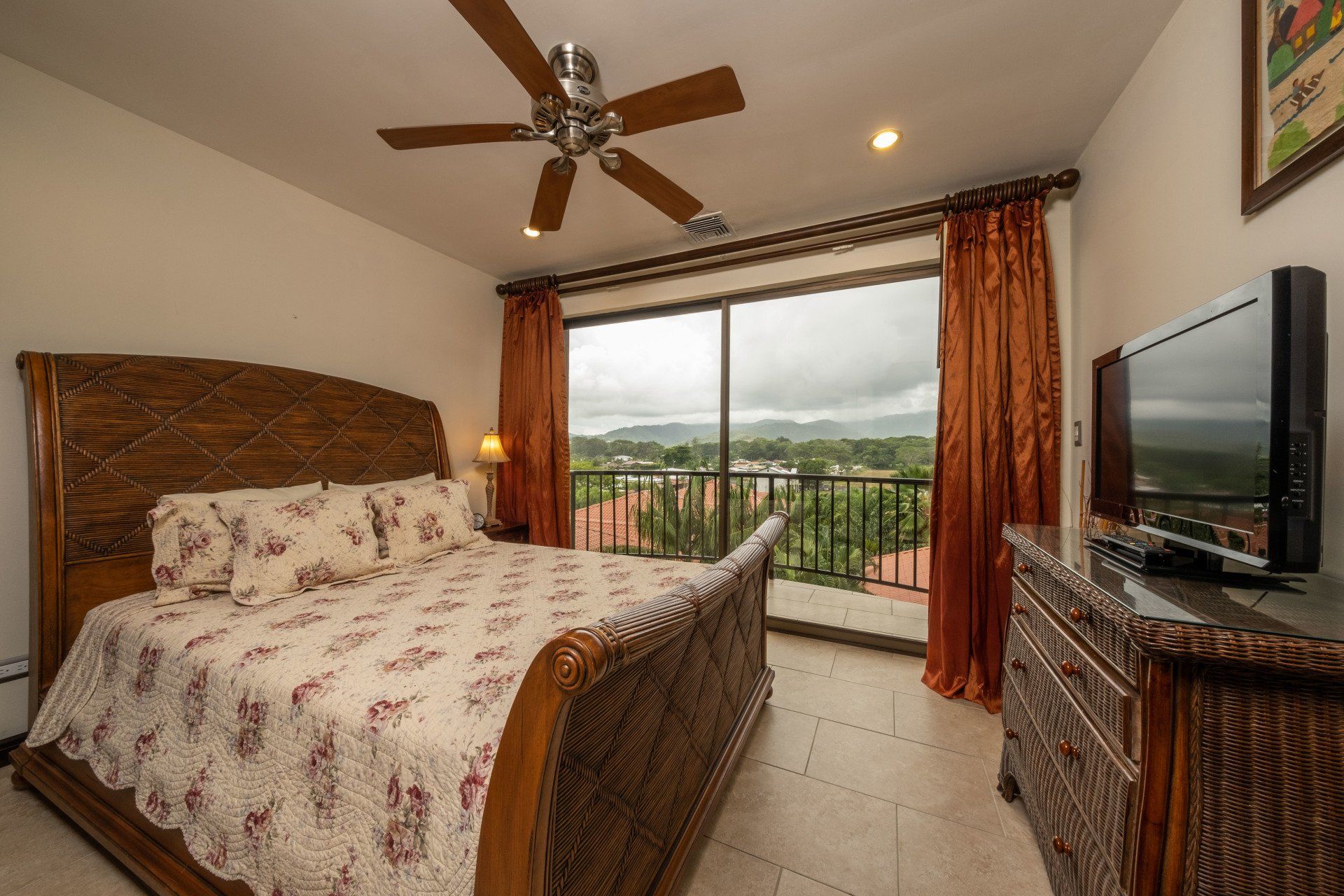 A bedroom with a large bed and a flat screen tv
