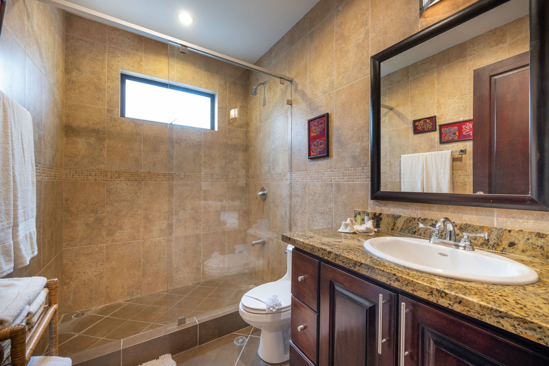A bathroom with a toilet , sink , and shower.