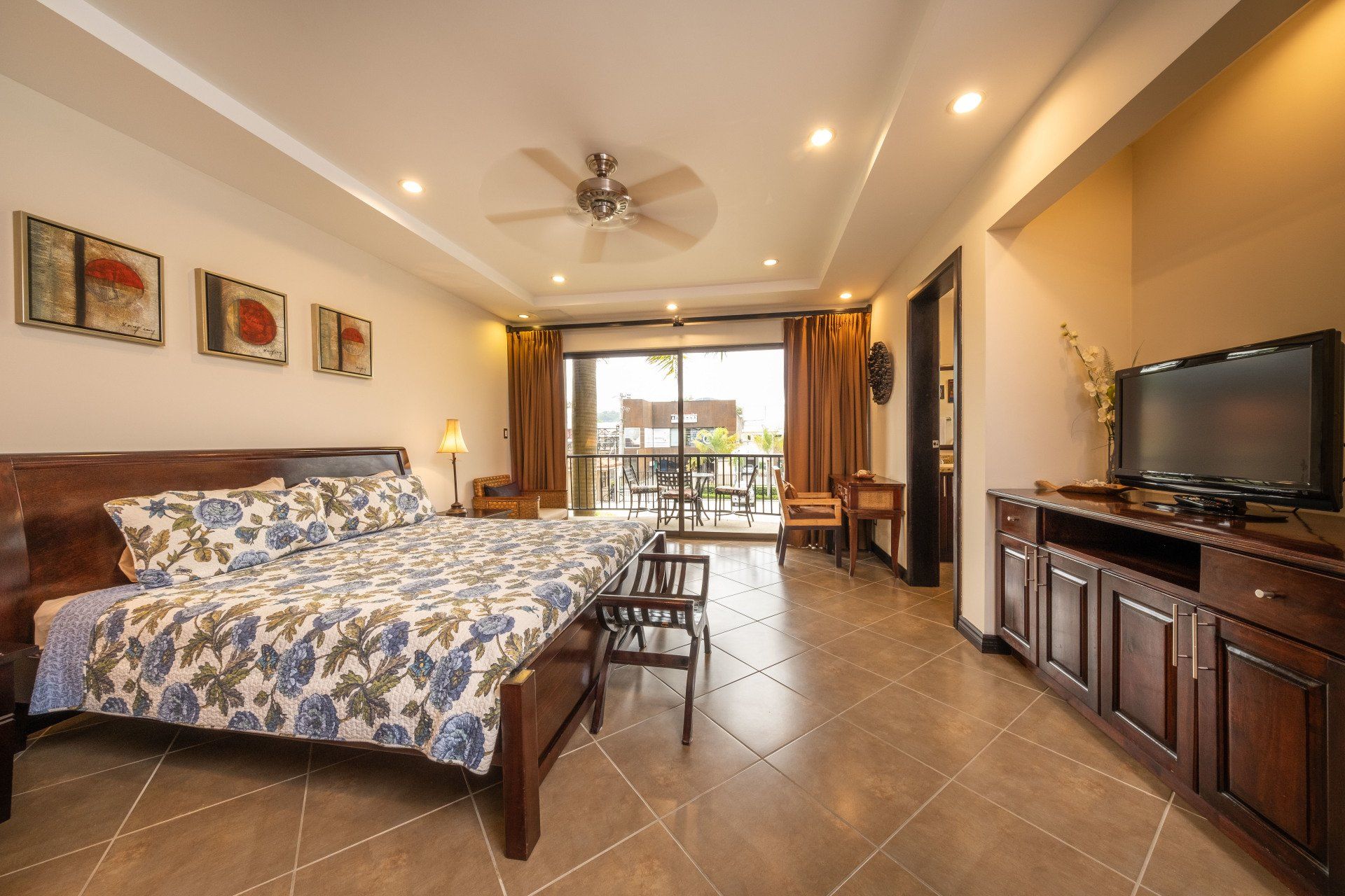 A bedroom with a large bed and a flat screen tv