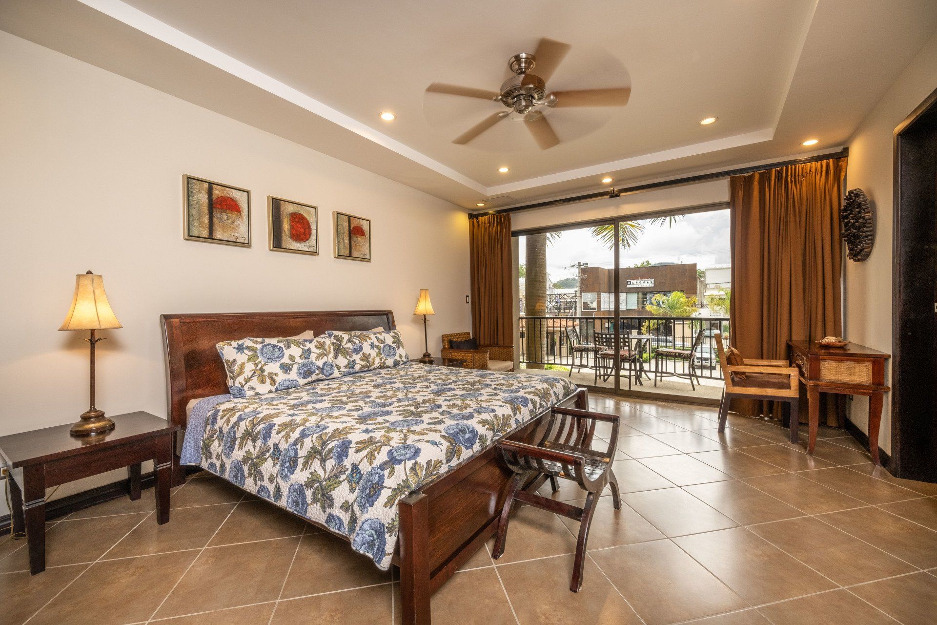A bedroom with a large bed and a ceiling fan