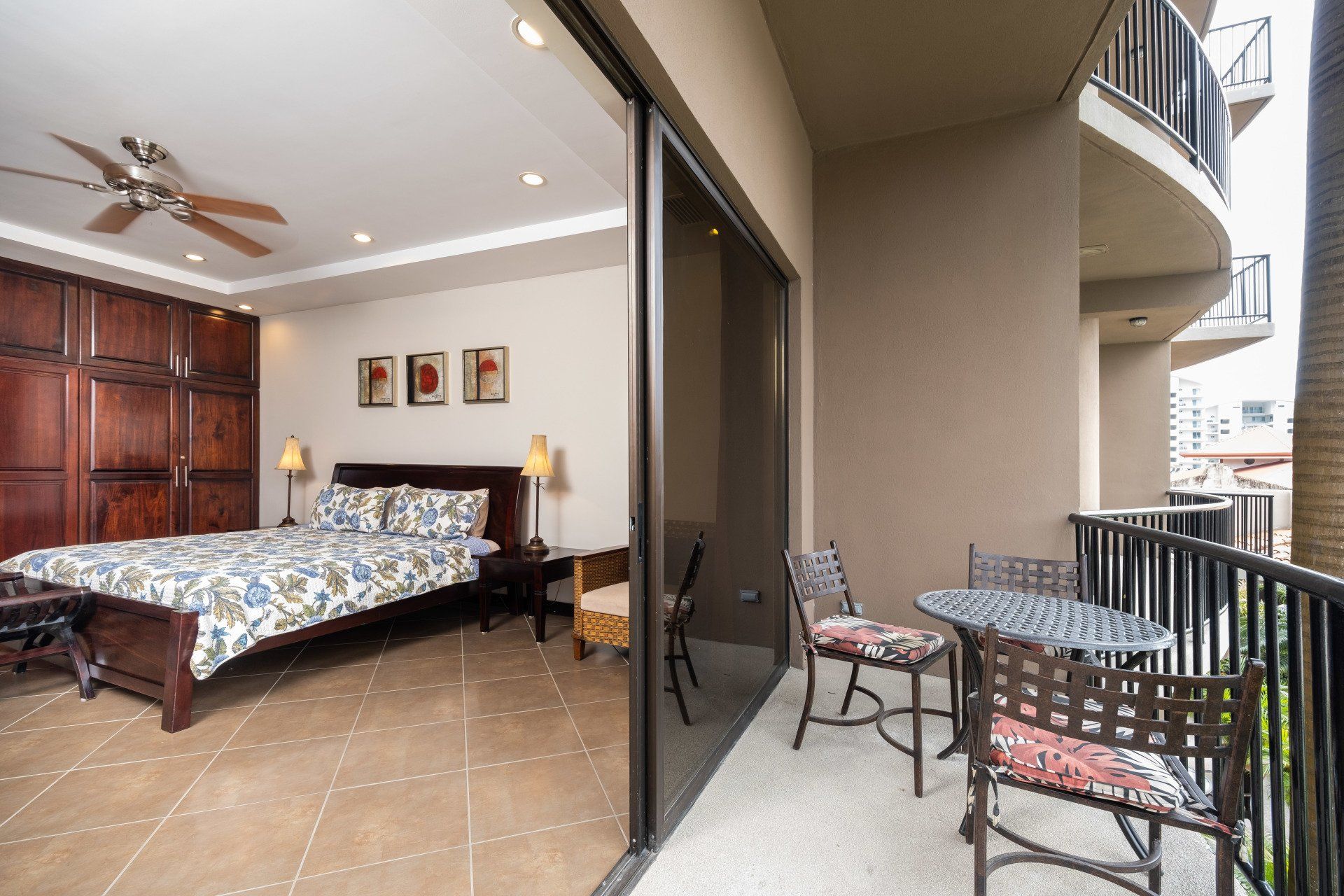 A bedroom with a large bed and a balcony
