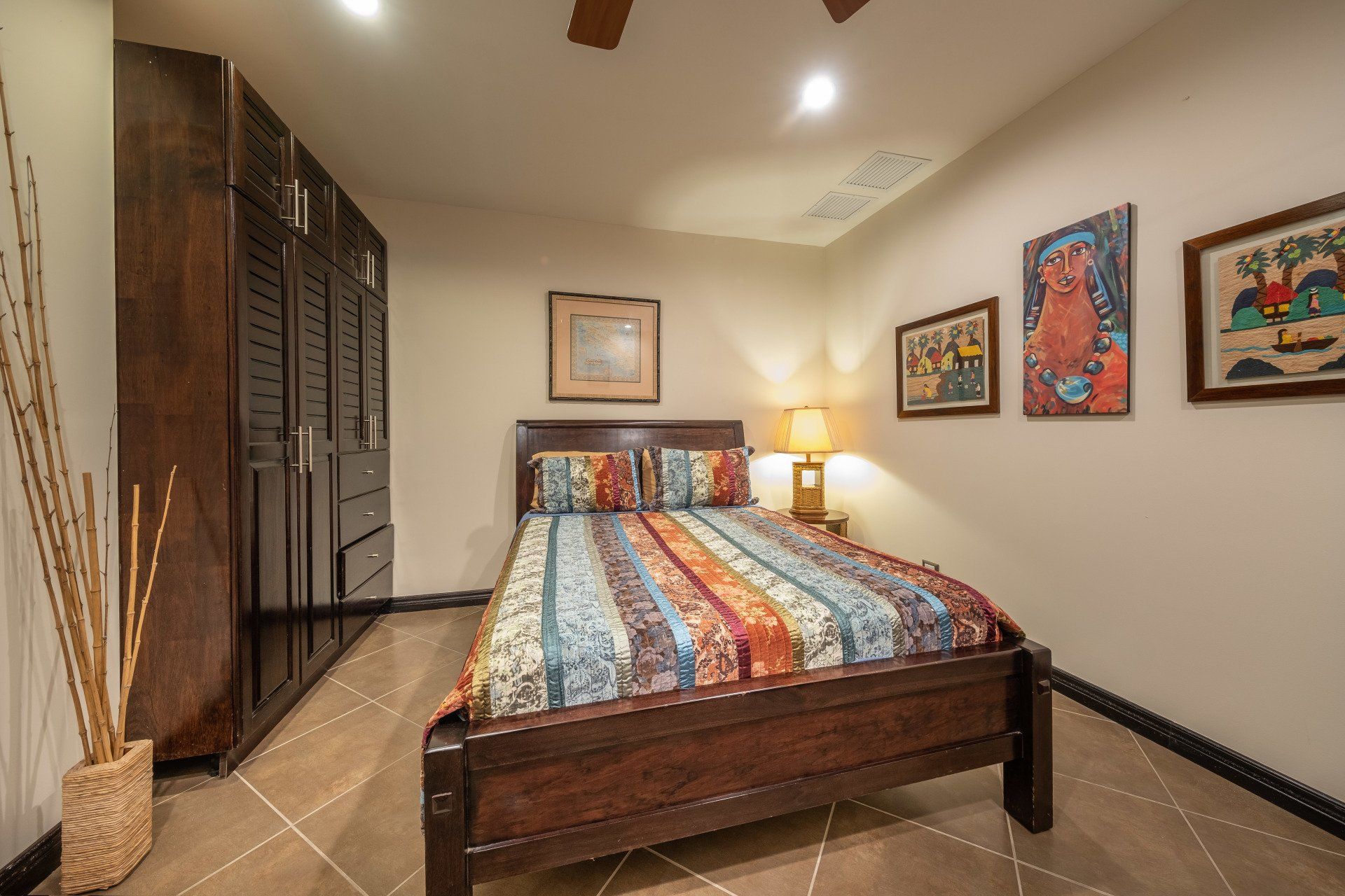 A bedroom with a bed and a ceiling fan