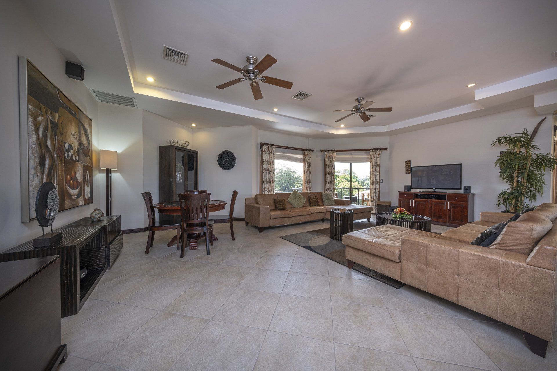A living room filled with furniture and a ceiling fan