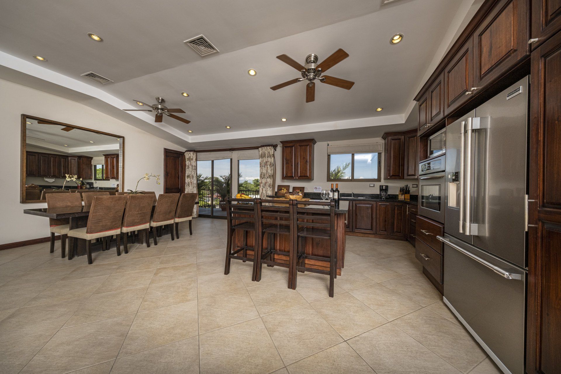 A large kitchen with stainless steel appliances and wooden cabinets