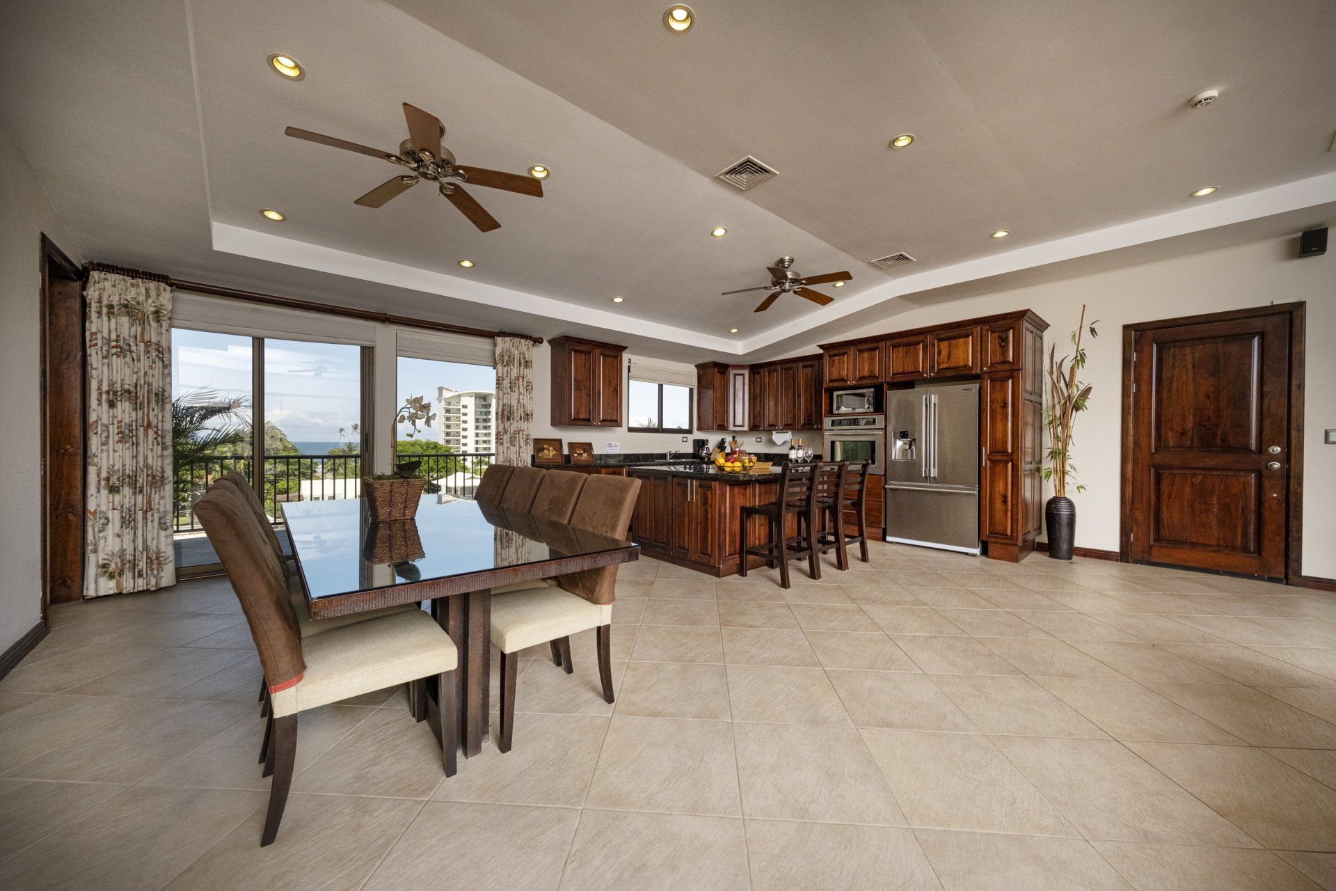 A kitchen with a table and chairs and a ceiling fan