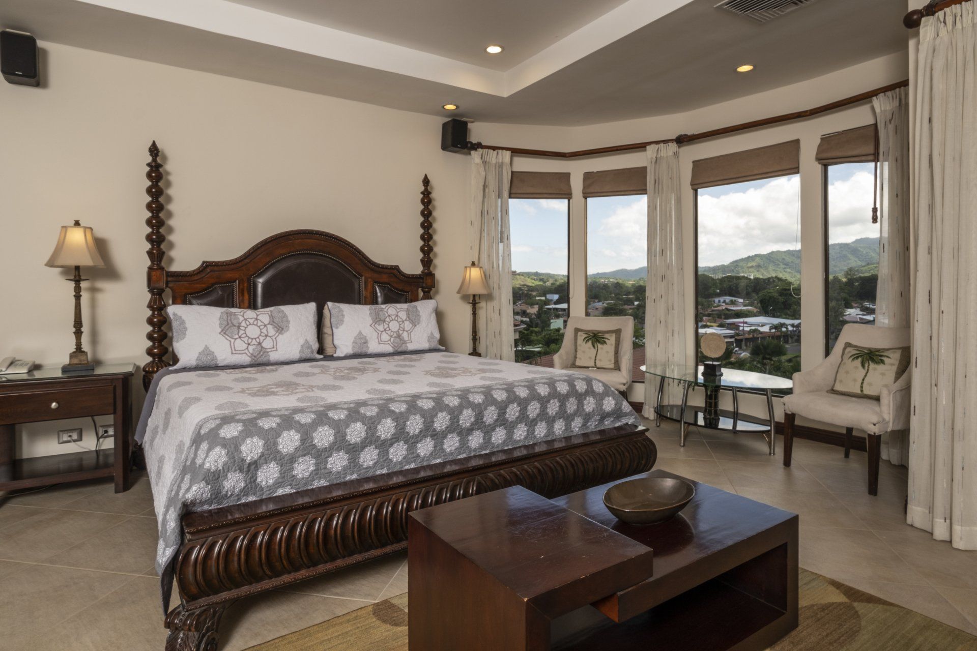 A bedroom with a king size bed and a coffee table