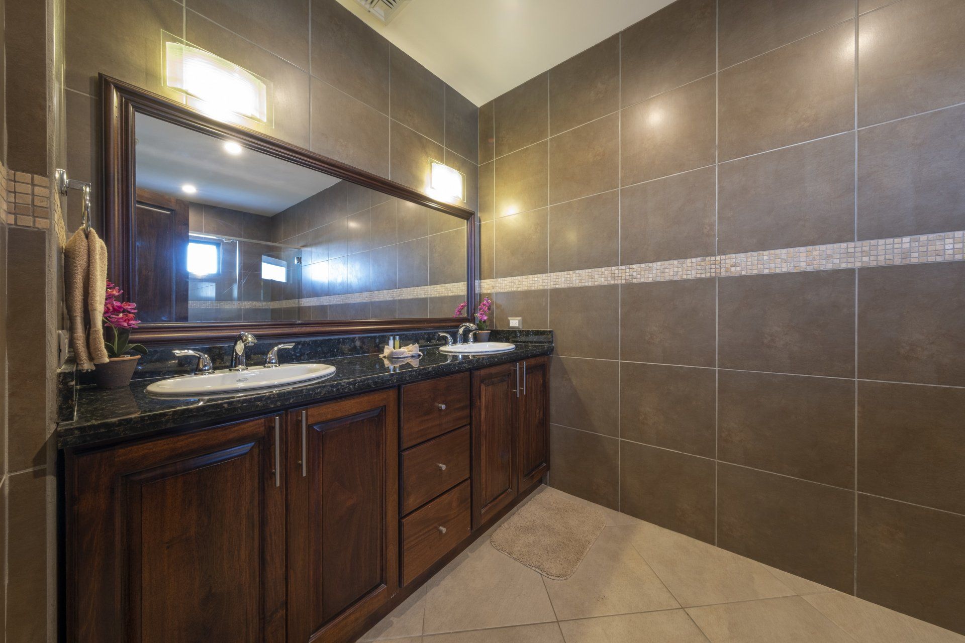 A bathroom with two sinks and a large mirror