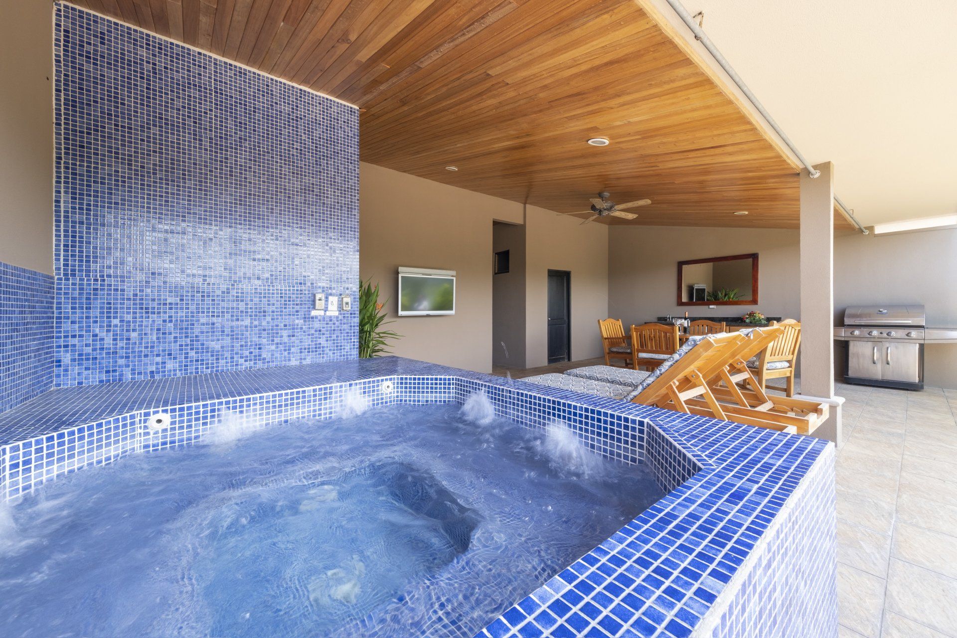 A swimming pool with a jacuzzi in the middle of it