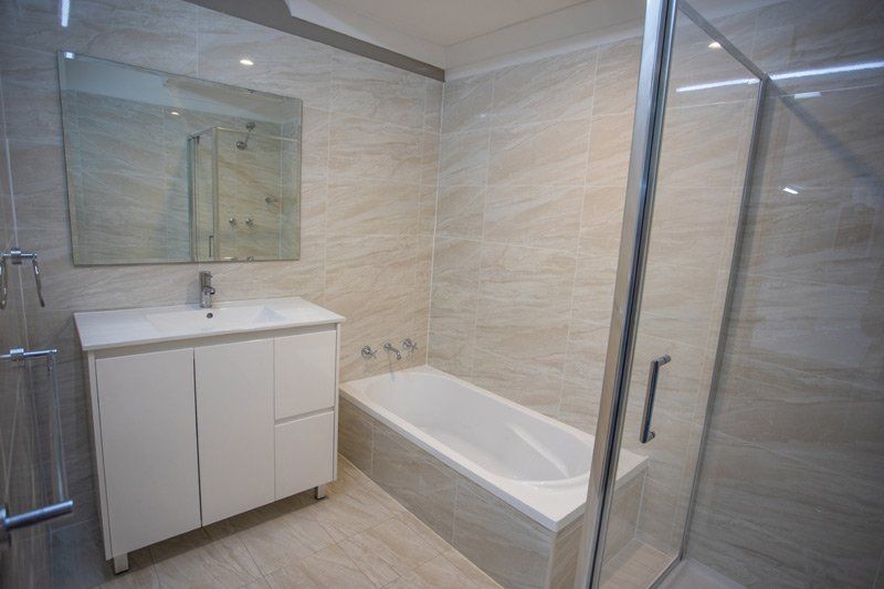tub and vanity in cream bathroom