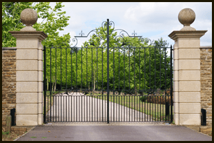 For iron gates and railings in Manchester call 07973 266 405 black iron gate with pillars either side