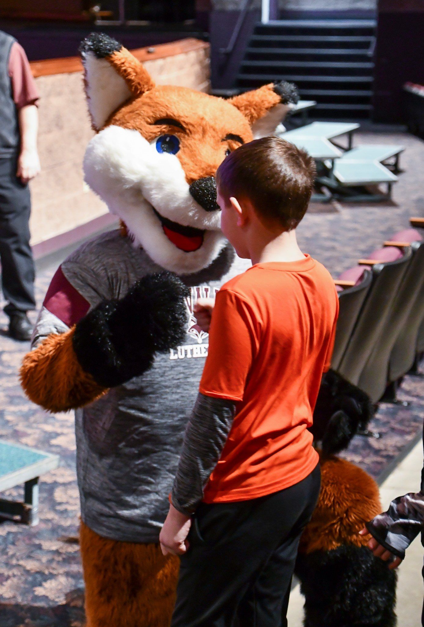FVL's mascot giving a fist bump to a 2nd grader
