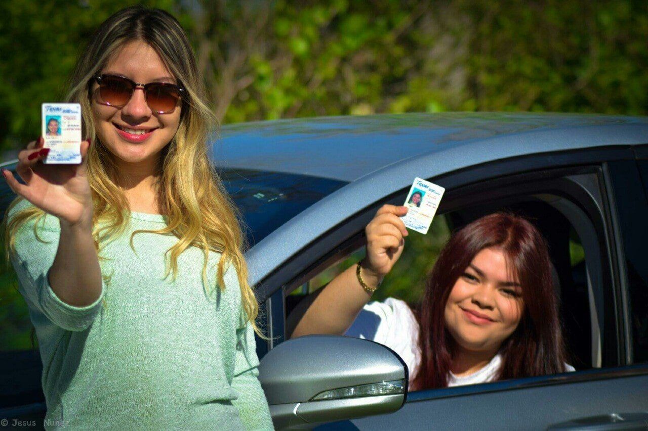 Two Women Holding IDs — Houston, TX — Driving School of Houston