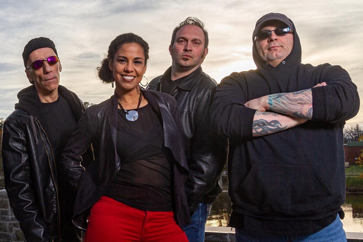 A group of people standing next to each other with their arms crossed.