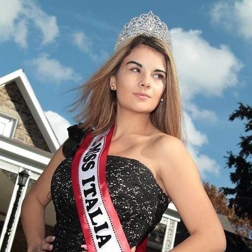 A woman is wearing a sash that says miss italia