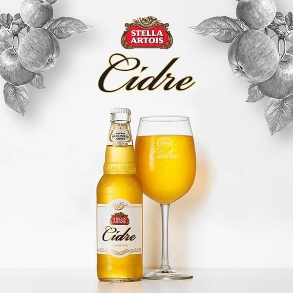 A bottle of stella artois cider next to a glass of cider