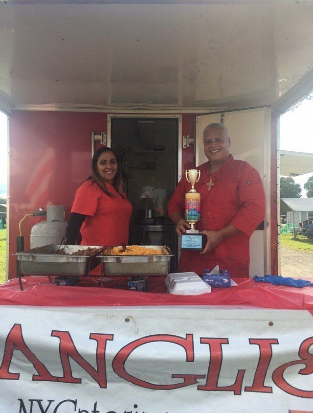 A man and a woman standing behind a sign that says angie