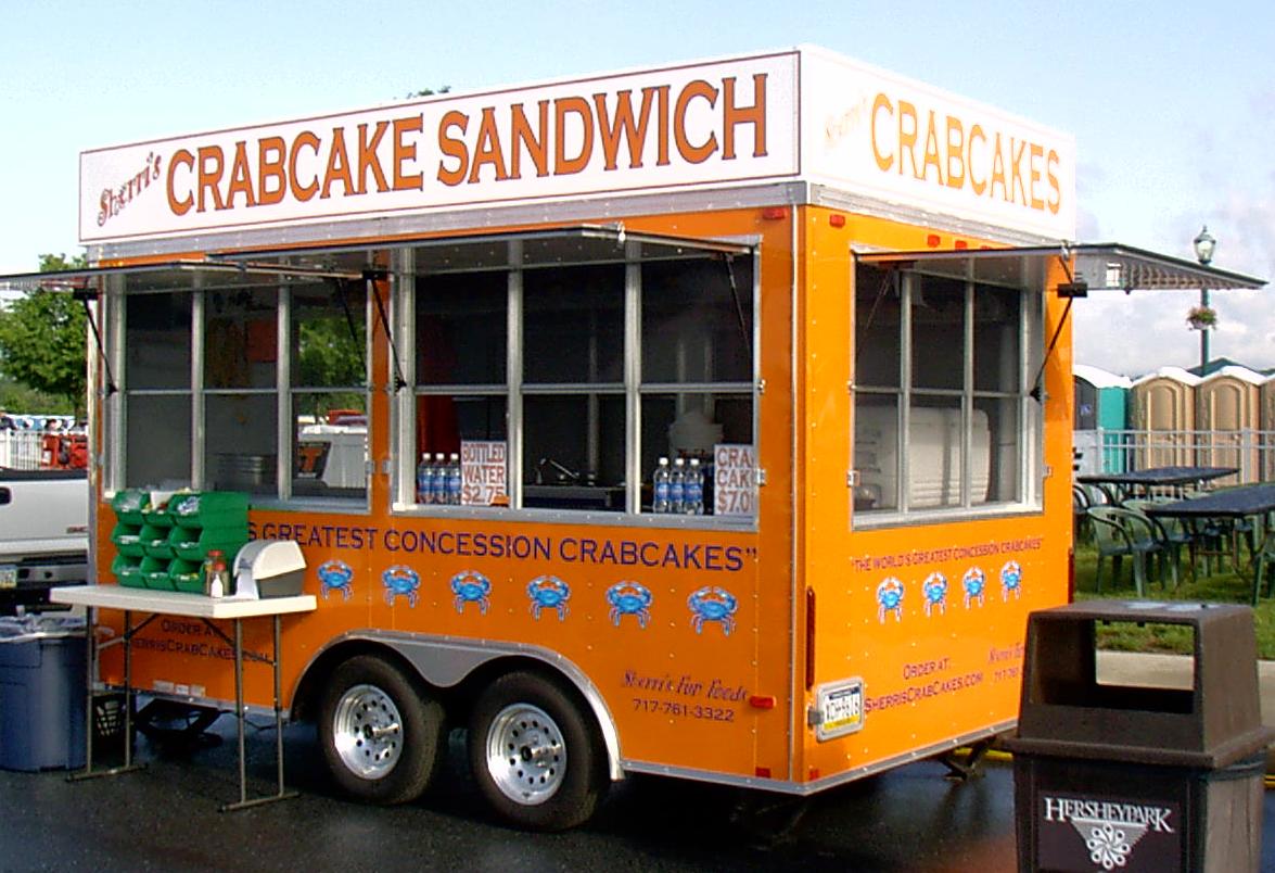 A crabcake sandwich food truck is parked in a parking lot