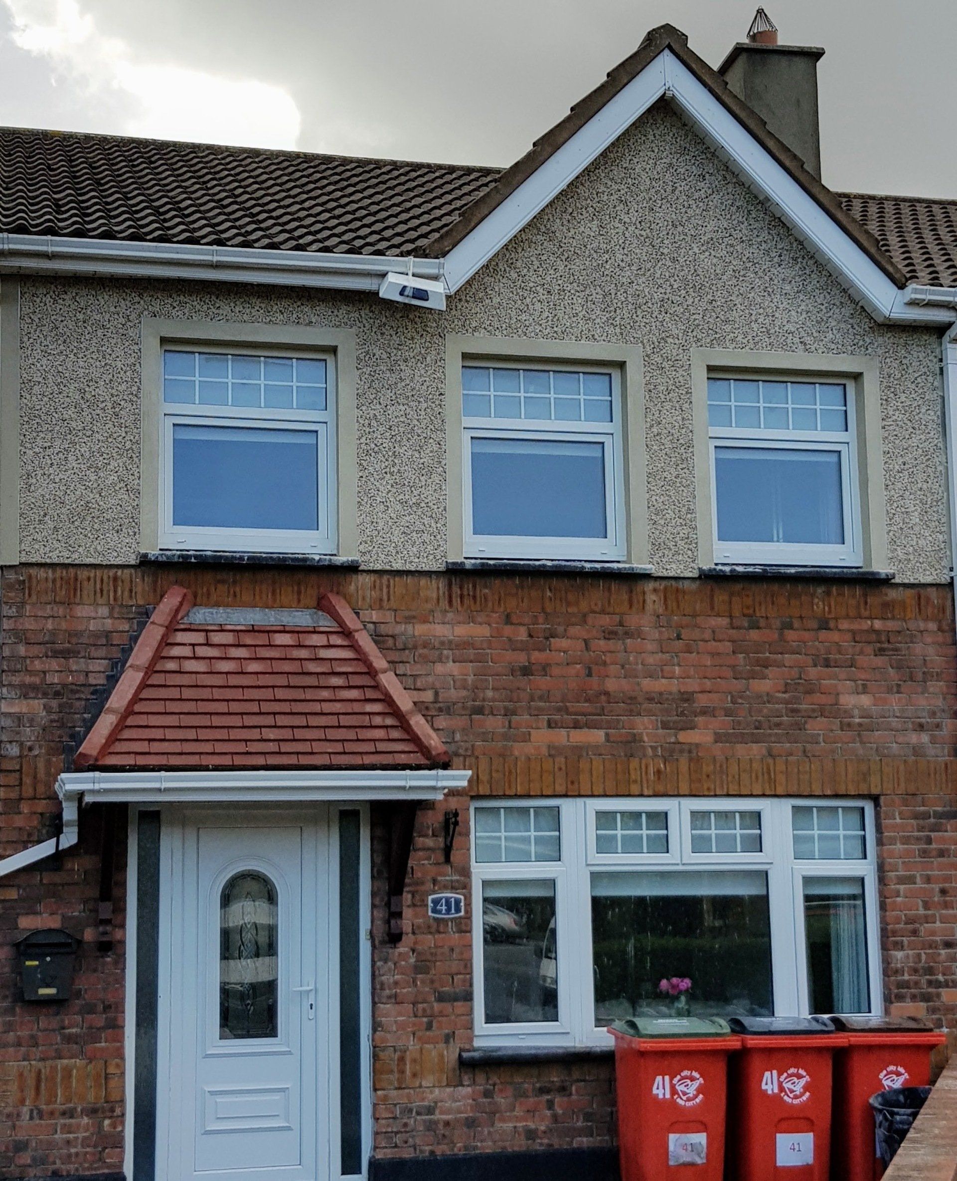 The front of a brick house with a white door