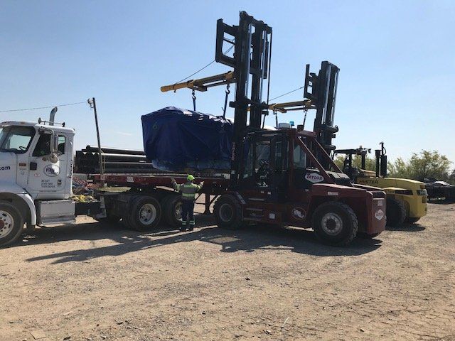 Large foklifts loading material onto trucks