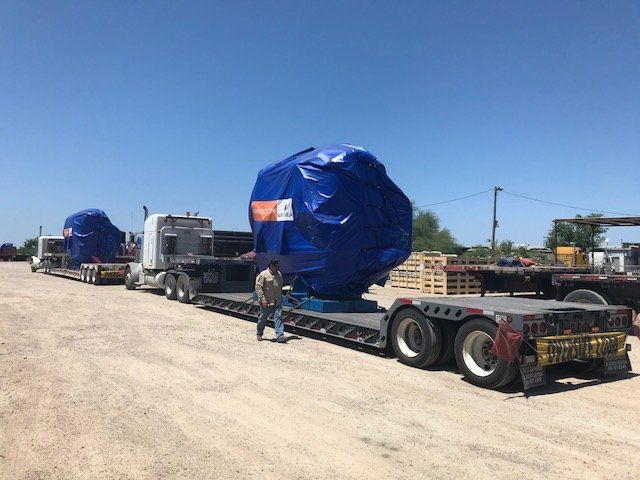 Flatbed trucks with blue items