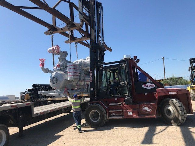Forklift loading equipment on flatbed truck