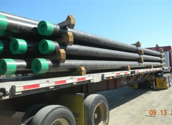Pipes secured onto flatbed truck