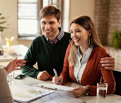 Couple Signing a Contract — Newton, MA — Bikofsky Insurance Agency Inc Couple Signing a Contract — Newton, MA — Bikofsky Insurance Agency Inc