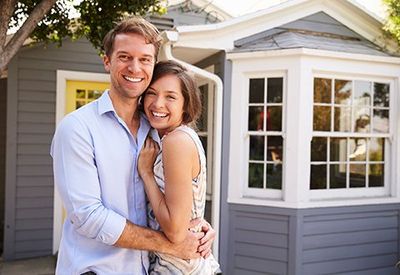 Couple Outside New Home — Newton, MA — Bikofsky Insurance Agency Inc Couple Outside New Home — Newton, MA — Bikofsky Insurance Agency Inc
