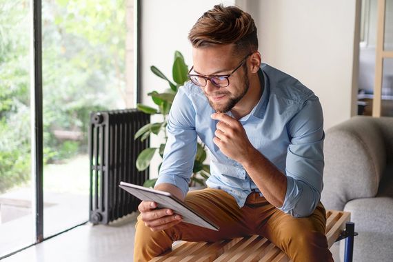 Man with Eyewear Using His Tablet Device — Chino, CA — Chino Optometry Center Man with Eyewear Using His Tablet Device — Chino, CA — Chino Optometry Center