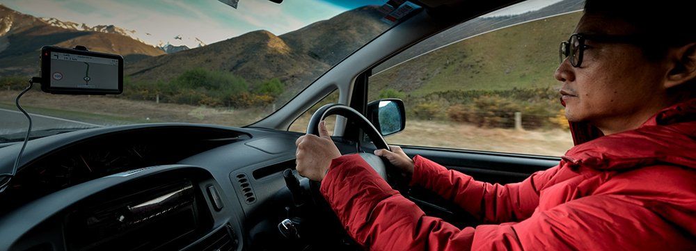 man in red coat driving in car