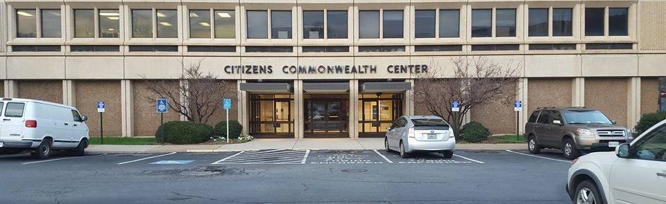 Cars are parked in front of a building that says citizens commonwealth center