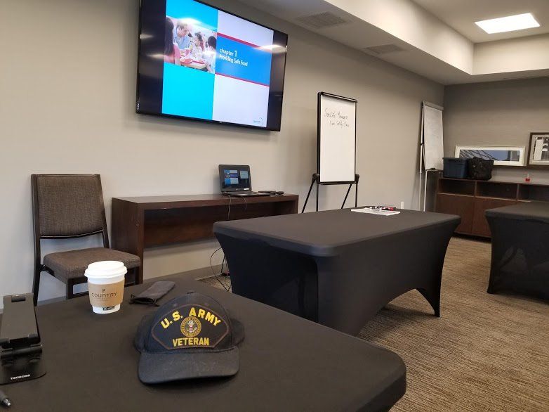 A u.s. army hat sits on a table in a conference room