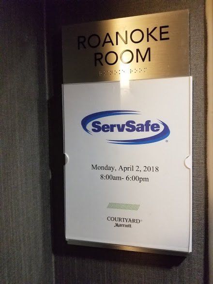 A sign that says roanoke room on it
