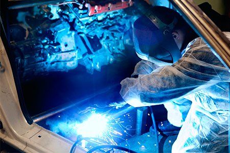 Frame Straightening — Mechanic at Work with the Car Body Frame in Staten Island, NY Frame Straightening — Mechanic at Work with the Car Body Frame in Staten Island, NY
