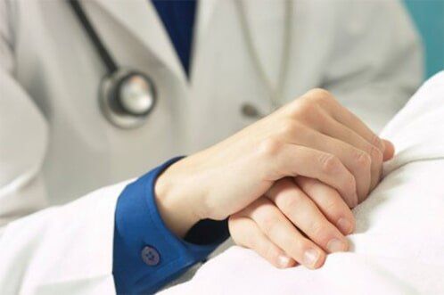 Doctor holding patient's hand — Clinics & Medical Centers in Philadelphia, PA Doctor holding patient's hand — Clinics & Medical Centers in Philadelphia, PA