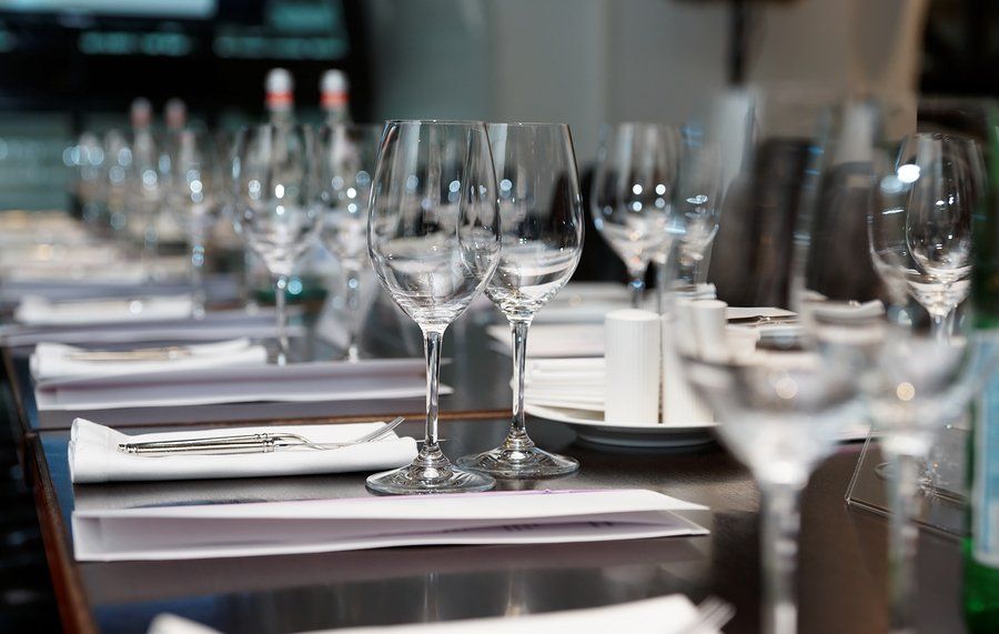 A row of wine glasses sitting on top of a table.
