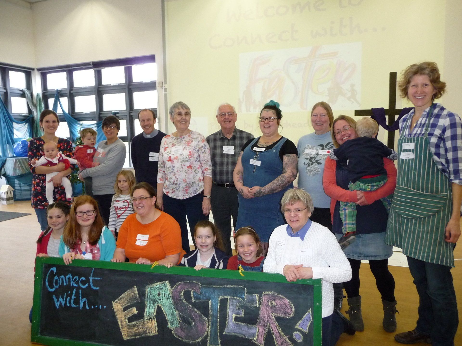 Group of people pose with a sign that says 