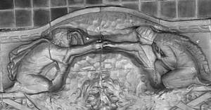 Foto von einer Wandskulptur im Alten Elbtunnel. Zwei personen reichen sich die Hand.