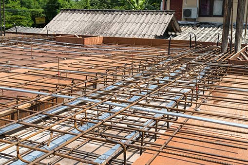 Reinforced steel framework for a concrete roof under construction.