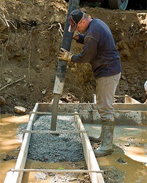 Ready-mix Concrete — Man Pouring Concrete in Southport, NC Ready-mix Concrete — Man Pouring Concrete in Southport, NC