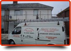 For plasterers in Plymouth call 01752 368 601 Company van parked outside a house with scaffolding