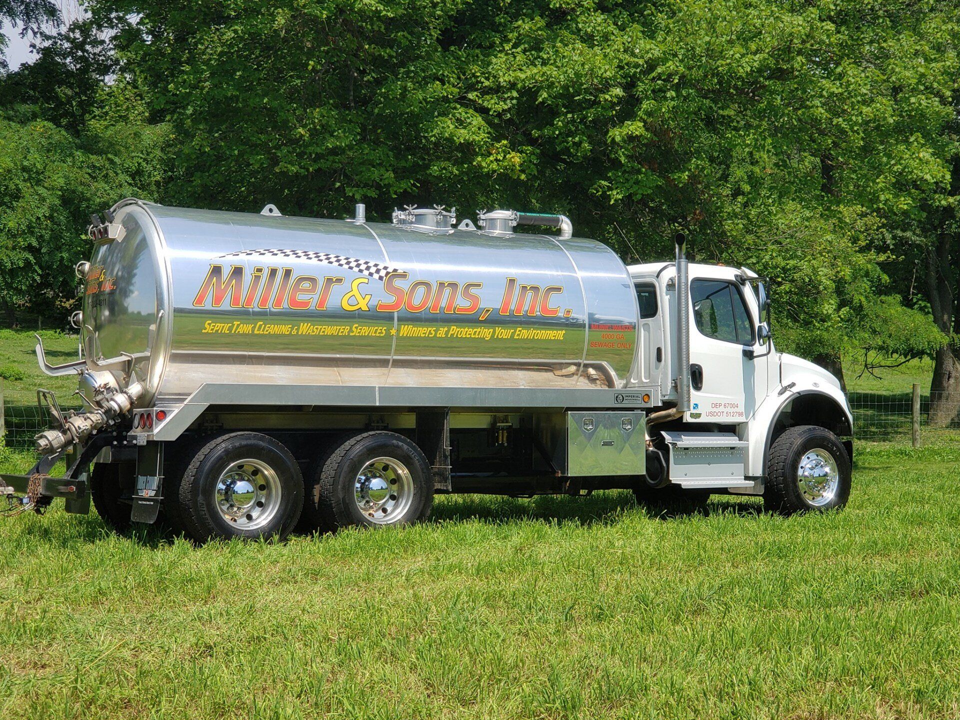 Septic tank truck, silver tank, white cab, 