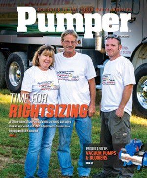 Three people in white shirts stand in front of a truck.