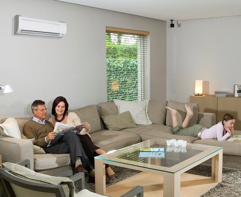 Family in living room with heat pump