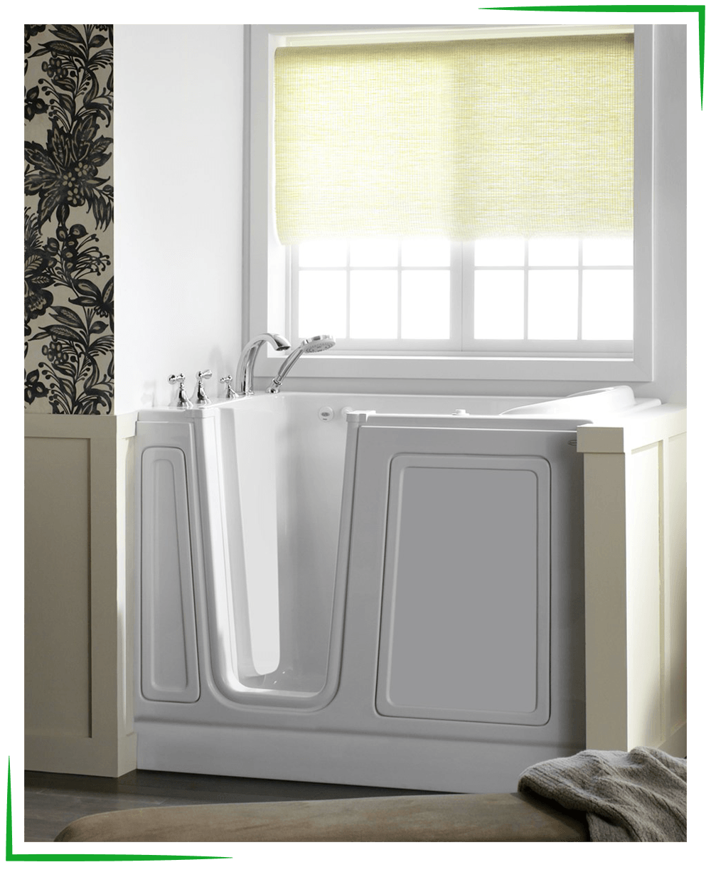 Walk-In Tubs - Missouri Bath & Window - Springfield, Missouri A white walk-in bathtub in a bathroom with a window, floral wallpaper, and a rolled-up blind.